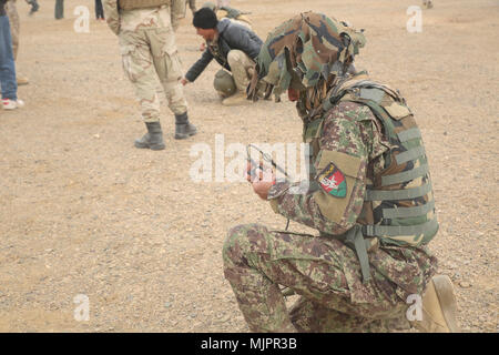 Eine nationale afghanische Armee Soldat mit 215 Corps bindet einen Abriss kostenlos an eine Amtsleitung im Camp Shorabak, Afghanistan, 26.12.2017. Rund 20 Techniker Soldaten ausgeführt ein Abriss Bereich, besteht Explosionsgefahr, Reduzierung der Kurs unter der Leitung von US-Beratern abgeschlossen. Die vierwöchige Schulung Evolution findet die Studenten aus der Route Spiel auf und unterrichtet sie die ordnungsgemäße Entsorgung Methoden der Improvised Explosive Devices, anschließend die Verbesserung der Mobilität der Truppen und der Lieferungen auf dem Schlachtfeld in der Provinz Helmand. (U.S. Marine Corps Foto von Sgt. Lucas Hopkins) Stockfoto