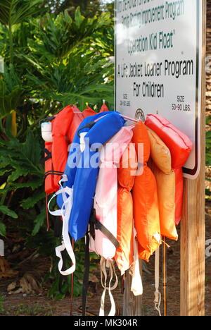 Colorful life preservers offered at the boat ramp to use for free to all boaters and guests who may need them in the coastal Gulf town of Dunedin, Fl. Stockfoto