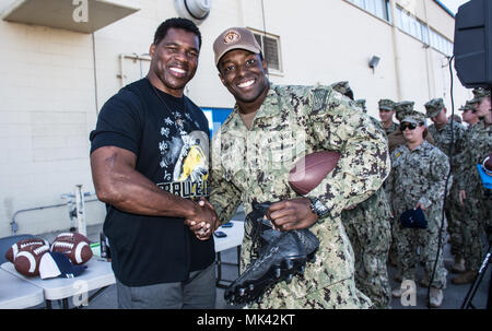 171102-N-NT 795-387 Imperial Beach, Calif (2. November 2017) Herschel Walker, Heisman Trophy Sieger, professioneller Athlet, Geschäftsmann und Autor, Zeichen der Fußball Schuhe für Intelligence Specialist 2. Klasse Joshua James, an die in den Küstenzonen Riverine Group (CRG) 1 Bei seinem Besuch an Bord Imperial Beach Naval Outlying Landeplatz zugeordnet. Walker stellt Service Mitglieder, Veteranen und militärische Familien emotionale und motivationale Unterstützung durch Vorträge auf militärische Einrichtungen im ganzen Land. (U.S. Marine Foto von Chief's Bootsmann Mate Nelson Doromal/Freigegeben) Stockfoto