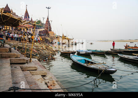 Varanasi, Uttar Pradesh, Indien: Ein Mann stand auf einer Bootsfahrt auf dem Ganges River sieht bei der kremation am Manikarnika Ghat. Im Hinduismus ein Dea Stockfoto