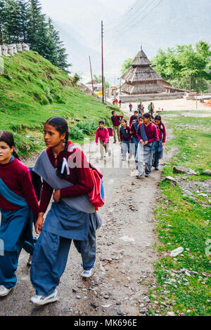 Nagar, Himachal Pradesh, Indien: Indische schoolchidren Spaziergang auf einer steilen Piste auf dem Weg nach Hause von der Schule in Naggar. Tripura Sundari Tempel Stockfoto