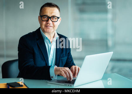 Positive Business Leader Sitzen im Büro Stockfoto