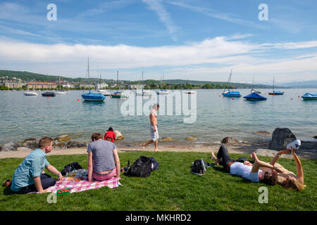 Die Menschen genießen Sie einen sonnigen Tag am Strandbad Mythenquai, am Ufer des Lake Zurich, Zürich, Schweiz, Europa Stockfoto