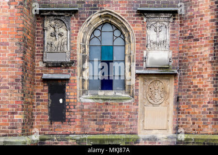 Detail eines Backstein Kathedrale im gotischen Stil. Geschnitzte Reliefs auf der Seite Fassade. Ein lancet Fenster. St. Maria Magdalena Kirche. Wroclaw, Polen. Stockfoto