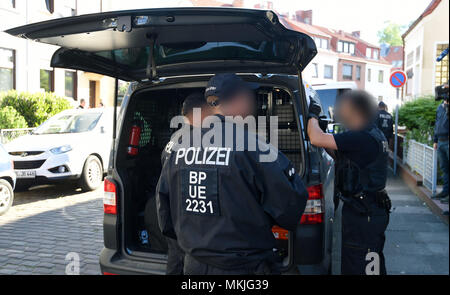 08 Mai 2018, Deutschland, Bremen: Polizisten ihre Streifenwagen, die Festgenommenen. Die deutsche Polizei hat eine groß angelegte Anti-menschenschmuggel Betrieb mit 800 Polizisten, die an Razzien in Wohnungen und Büros in Nord- und Mitteldeutschland. Der Grund für die Razzien wird die vermutete kommerzielle und Schleifring-basierten Handel mit Ausländern. Foto: Carmen Jaspersen/dpa - ACHTUNG: Individuelle(s) ist/sind verpixelt aus rechtlichen Gründen. Stockfoto