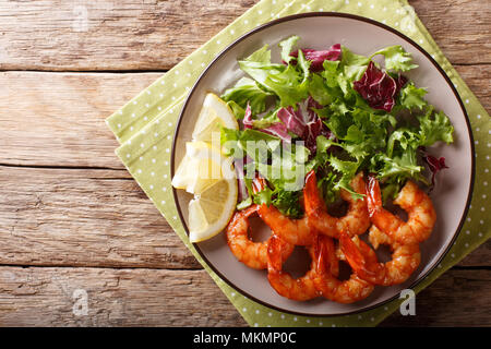 Garnelen gebraten in Sojasauce und frischem Salat close-up auf einem Teller. horizontal oben Ansicht von oben Stockfoto