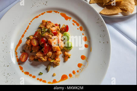 Ceviche de Lachs, pikante kalte Lachs Salat mit Tomaten und Avocado Stockfoto