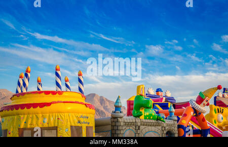 Bunte aufblasbare springen Schlösser für Kinder in der Children's Park unter einem blauen Himmel. Stockfoto