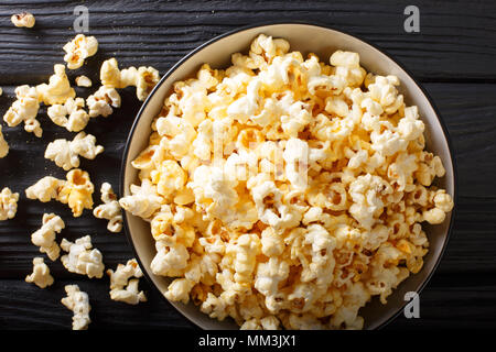 Beliebter Snack: gesalzene Popcorn mit Cheddar Käse und Parmesan in eine Schüssel close-up auf den Tisch. Horizontal oben Ansicht von oben Stockfoto