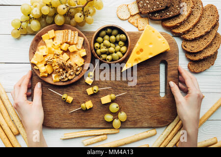 Frau mit Holzbrett mit Käse Stockfoto