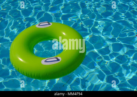 Grüne Gummiring auf dem Wasser im Pool Stockfoto