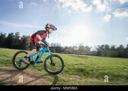 Little boy Schnellfahren auf dem Mountainbike, Bayern, Deutschland Stockfoto