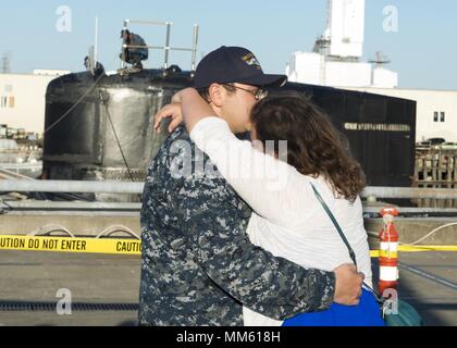 BREMERTON, Washington (7. Mai 2018) Elektroniker 2. Klasse Zachary Raschellanicholas, aus Phoenix, Arizona, zugeordnet zu den Seawolf-Klasse schnell-Angriffs-U-Boot USS Connecticut (SSN 22), küsst seine Frau, nachdem das Boot kehrt nach Hause zurück zu Naval Base Kitsap-Bremerton nach Abschluss der multinationale maritime Ice-Übung (ICEX) in den Polarkreis, 7. Mai 2018. ICEX 2018 ist ein 5-wöchigen Übung, die Marine ihre Einsatzbereitschaft in der Arktis, die Erfahrung in der Region, Vorauszahlung Verständnis der arktischen Umwelt zu beurteilen, und weiterhin Beziehungen zu entwickeln. Stockfoto