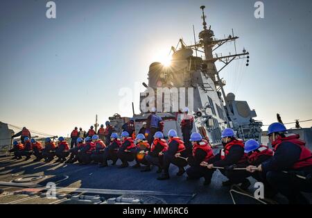 170909-N-UY 653-257 POLARKREIS (Sept. 9, 2017) Matrosen an Bord der Arleigh-Burke-Klasse geführte Anti-raketen-Zerstörer USS Oscar Austin (DDG79) Linie griff während einer Auffüllung-auf-See mit der Royal Fleet Auxiliary schnelle Flotte Tanker RFA Wave Ritter (A 389) Sept. 9, 2017. Oscar Austin auf einer routinemäßigen Bereitstellung unterstützen die nationale Sicherheit der USA Interessen in Europa und der zunehmenden Theater Sicherheit gute Zusammenarbeit und freuen uns naval Präsenz in den USA 6 Flotte Bereich der Operationen. (U.S. Marine Foto von Mass Communication Specialist 2. Klasse Ryan U. Kledzik/Freigegeben) Stockfoto