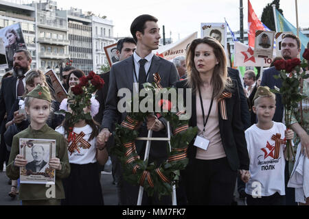 Athen, Griechenland. 9. Mai, 2018. Eine russische Paare mit ihren Kindern gesehen Teilnehmenden während der Unsterblichen Regiment März. Tausende von russischen Bürgern in die Feiern zum 73. Jahrestag des Sieges gegen den Faschismus, der als Tag des Sieges hergestellt wurde teilgenommen. Mit dem Militär parade sowie die Demonstration, die festliche Veranstaltung fand in ganz Russland, mit den Bürgerinnen und Bürgern halten Fotos ihrer Verwandten, die entweder während des Weltkrieges gekämpft haben oder getötet wurden. Credit: Nikolas Joao Kokovlis/SOPA Images/ZUMA Draht/Alamy leben Nachrichten Stockfoto