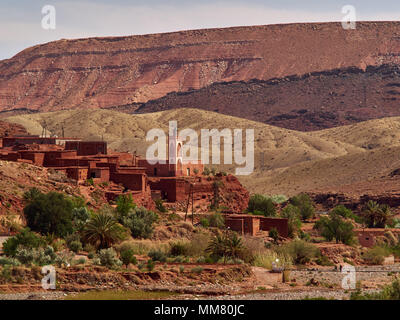 Alte Moschee und kleines Dorf mit Adobe Häuser am Ufer des Flusses, Ouarzazate, Marokko. Stockfoto