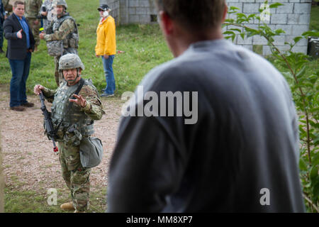 Sgt. Marc Stelter, Soldat mit Charlie Company (C Co.), 457Th zivilen Angelegenheiten Bataillon (CA MRD.), interagiert mit einer Rolle-Player während der Übung Cobra Strike 17 von C Co, 457Th CA BN, in Wackernheim, Deutschland, Sept. 16, 2017. Diese lokale multi-partnered Übung tests Bewertung Fähigkeiten zivile Angelegenheiten Lote' in einer fiktiven nach der Erdbebenkatastrophe Szenario und Abstimmung mit den örtlichen Rettungsdienst (U.S. Armee finden Foto vom Kapitän Jeku Arce, 221St Public Affairs Distanz). Stockfoto