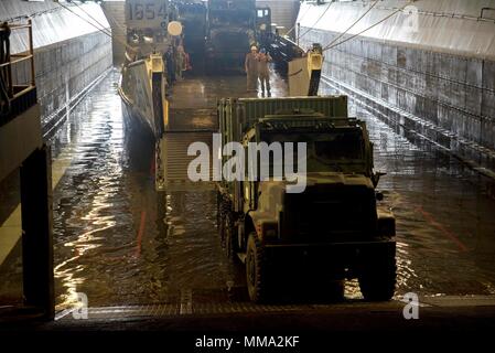 170926-N-WH 681-062 karibische Meer (bis 30. 26, 2017) Fahrzeuge mit Generatoren und andere Geräte eine Landing Craft Utility in das Deck des Amphibious Assault ship USS Kearsarge (LHD3) für den Transport in Puerto Rico. Kearsarge unterstützt mit Hilfsmaßnahmen in den Wirbelsturm Maria. Das Verteidigungsministerium ist die Unterstützung der Federal Emergency Management Agency, die federführende Bundesbehörde, dabei helfen, die Betroffenen durch den Hurrikan Maria Leiden zu minimieren und ist ein Bestandteil der gesamten-von-Reaktion seitens der Regierung. (U.S. Marine Foto durch Massenmedien. Stockfoto