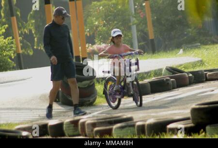 Madiun, Indonesien. 10. Mai, 2018. Kleine Kinder Erwachsene Radfahren pancal am Morgen Credit: Ajun Ally/Pacific Press/Alamy leben Nachrichten Stockfoto