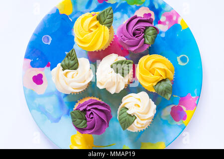 M&S mini rose Cupcakes auf bunte Platte Stockfoto