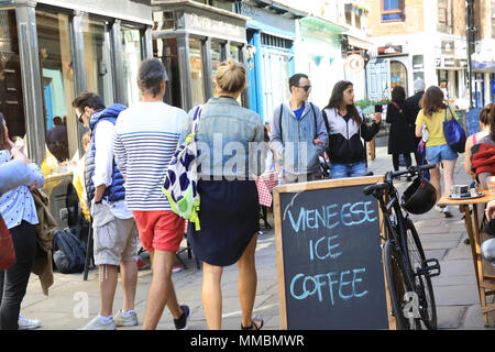 Paar zu Fuß durch die Cafés und Geschäfte auf trendige Camden Passage aus Upper Street, Islington, London, UK Stockfoto