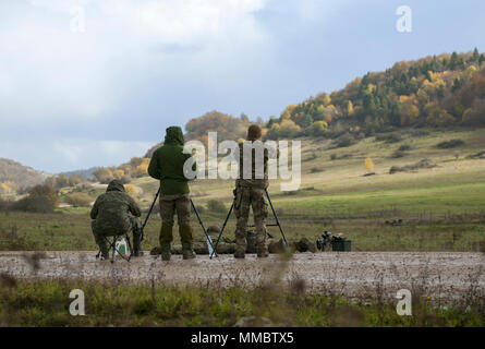 Ausbilder beobachten, wie eine Zwei-sniper Team eine unbekannte Abstand Test während des Basic Sniper Kurs durch die International Special Training Center am Joint Multinational Readiness Center in Hohenfels, Deutschland, 22. Oktober 2017 durchgeführt. Das ISTC ist eine multinationale Ausbildung und Training Service die Advanced bietet und spezielle Ausbildung auf der taktischen Ebene für Sondereinsatzkräfte und ähnliche Geräte aus der Vereinbarung, bei der NATO und der Partnerschaft für den Frieden der Nationen. (SOCEUR Stockfoto