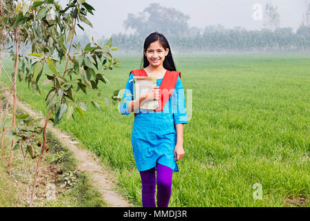 Ländliche Dorfbewohner Jugendmädchen Student Holding Bücher wandern In-Farm Stockfoto