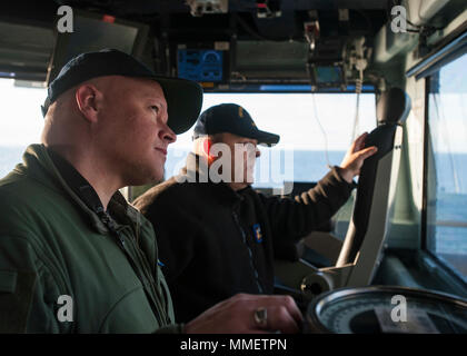 171028-N-ME 396-279 Norfolk, Virginia (Okt. 2010) 28, 2017) Kapitän Chris Hill, Executive Officer der USS George H.W. Bush (CVN 77), und Senior Chief Quartermaster John Schulen stand auf der Brücke, während USS George H.W. Bush (CVN 77) kehrt in Homeport nach Abschluss der Übung Bold Alligator 2017 (#BA 17). Verbesserung Navy-Marine Corps amphibische Kernkompetenzen zusammen mit Koalition, North Atlantic Treaty Organisation (NATO), Verbündete und Partner Nationen ist eine notwendige Investition in die aktuelle und zukünftige Bereitschaft unserer Kräfte. BA 17 statt Okt. 18 - 28, 2017, an Land entlang der Ostküste. Stockfoto