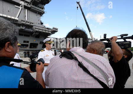 171031-N-VO 234-1143 Santa Rita, Guam (Okt. 31, 2017) Kapitän Carlos Sardiello, kommandierender Offizier der Flugzeugträger USS Theodore Roosevelt (CVN 71), spricht mit den Medien am Marinestützpunkt Guam. Das Schiff ist in Guam für einen geplanten Hafen besuchen. Theodore Roosevelt ist derzeit in den USA 7 Flotte Bereich für Maßnahmen zur Erhöhung der Sicherheit des Seeverkehrs und Theater Sicherheit Zusammenarbeit bereitgestellt werden. (U.S. Marine Foto von Mass Communication Specialist 2. Klasse Conor Minto/Freigegeben) Stockfoto