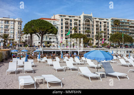 Frankreich, Cannes Stadt, Strand mit Liegestühlen auf dem französischen Riviera, Gebäude entlang der Boulevard de la Croisette Stockfoto