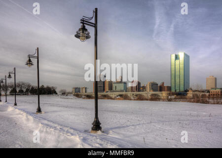 Ein Blick auf die Innenstadt von Toledo Ohio Skyline aus über die gefrorene und schneebedeckten Maumee River schöne leicht bewölkt blauer Himmel. Stockfoto