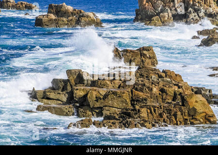 Wellen schlagen Felsen Stockfoto