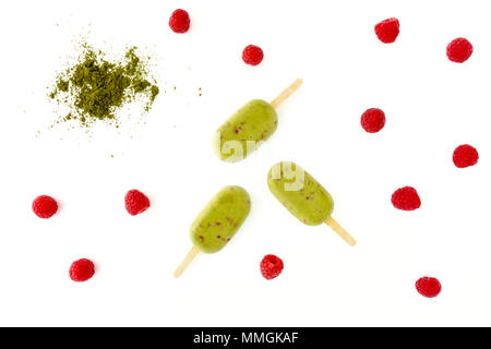 Matcha und Himbeere Eis am Stiel auf weißem Hintergrund mit Matcha Pulver und frischen Himbeeren. Stockfoto