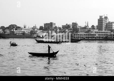 Dhaka, Bangladesh, 24. Februar 2017: rudern Boote auf dem Fluss Buriganga in Dhaka, Bangladesch und im Hintergrund die alte Werft Stockfoto