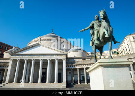 Blick auf die Basilika Reale Pontificia San Francesco Di Paola durch eine bronzene Reiterstatue von Ferdinand I. von Bourbon in Neapel, Ital dominiert Stockfoto