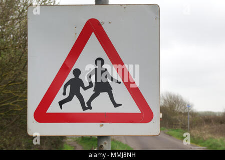 Alte, verwitterte, rote und weiße dreieckige Verkehrssicherheit zeichen Kinder Schule überqueren Fußgänger sicher Stockfoto