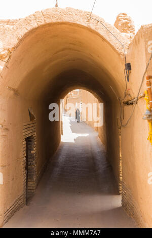 YAZD, IRAN - 27. APRIL 2015: Eine nicht identifizierte Frau geht durch die Straßen von Yazd im Iran Stockfoto