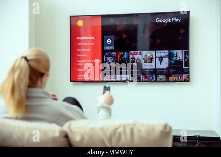 WROCLAW, Polen - April 03rd, 2018: Frau ist mit Google spielen auf Ihrem TV. Google Play ist eine digitale Distribution Service betrieben und von Goog entwickelt Stockfoto