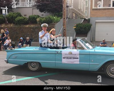 Kapitän William Timmons, Commander, Coast Guard Sektor Columbia River, und seine Frau Laura Süßigkeit während das Astoria Regatta Parade in der Innenstadt von Astoria, Erz, 12.08.2017, werfen. Das Astoria Regatta ist eine jährliche Veranstaltung, die zusammen bringt die Stadt und seine reiche maritime Geschichte. U.S. Coast Guard Foto von Lt.Cmdr. Christopher Morris. Stockfoto