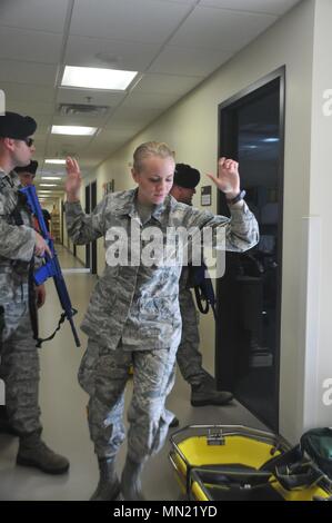 Die Sicherheitskräfte mit Die 128 Luftbetankung Flügel, Wisconsin Air National Guard, Leerpumpen Flieger während eines aktiven shooter Übung 13.08.2017. Das US-Ministerium für Heimatschutz" laufen, verstecken, oder Kämpfen"-Kampagne betont ruhig zu bleiben und die folgenden Anweisungen, wenn Strafverfolgungsbehörden ankommt. (U.S. Air National Guard Foto von älteren Flieger Morgan R. Lipinski/Freigegeben) Stockfoto