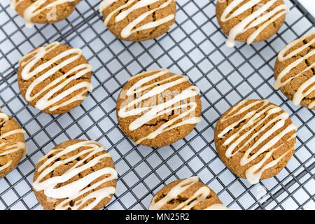 Frisch gebackene, hausgemachte pumpkin Spice Cookies, mit Ahorn Vereisung. Diese Gluten und ohne Milchprodukte Kekse sind auf einem Gitter angezeigt. Stockfoto