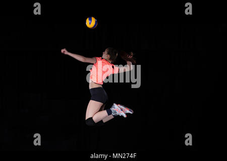 Junge Frau Volleyballspieler auf schwarzem Hintergrund Stockfoto