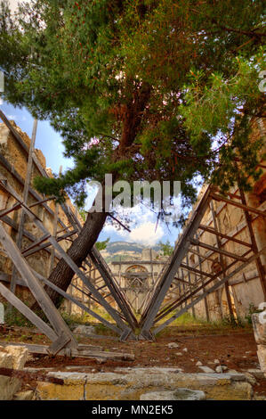 Die antike Ruine des Klosters Sisia auf Kefalonia, stark durch das Erdbeben 1953 beschädigt, kaum zusammenzuhalten, Holz- streben. Stockfoto