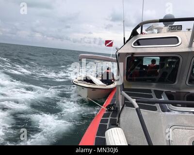 Ein Coast Guard Station Islamorada 33-Fuß-Special Purpose Craft-Law Durchsetzung boatcrew Seite ziehen eines Sportboote Islamorada, nachdem das Boot begann Nehmen auf Wasser in der Nähe von Alligator Reef Freitag, August 25, 2017. Die station Besatzung gerettet, drei Erwachsene und ein Kind. U.S. Coast Guard Foto mit freundlicher Genehmigung der Station Islamorada Stockfoto