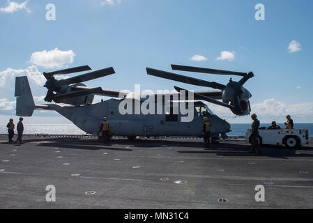 170825-N-NB 544-029 CORAL SEA (Aug. 25, 2017) der Luftfahrt Bootsmann Gehilfen (Handling) verwenden Sie ein ALS 32/A-39 an Bord Schlepper eine MV-22 B Osprey, zugeordnet zu den 'Dragons" der Marine Medium Tiltrotor Squadron (VMM) 265 (Verstärkt) zu bewegen, auf dem Flugdeck des Amphibious Assault ship USS BONHOMME RICHARD (LHD6). Bonhomme Richard, dem Flaggschiff der Bonhomme Richard Expeditionary Strike Group, ist die in der pazifischen Region Indo-Asia Partnerschaften zu verbessern und eine fertige Antwort für jede Art von Kontingenz. (U.S. Marine Foto von Mass Communication Specialist 2. Klasse Kyle Carlstrom/Rele Stockfoto