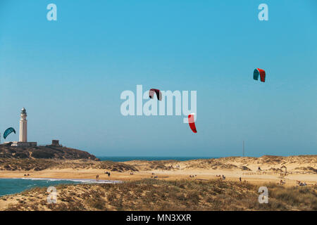 Leute, Kitesurfen am Strand von Los Caños de Meca, neben dem Leuchtturm von Trafalgar, an der Küste von Cadiz, Spanien Stockfoto