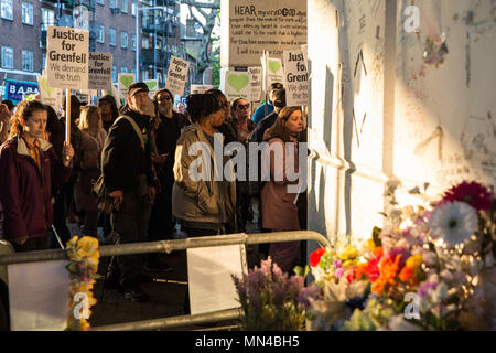 London, Großbritannien. 14 Mai, 2018. Mitglieder der Grenfell Gemeinschaft einen Schrein, der den Grenfell Turm Feuer unter dem Westway flyover starb an Latimer Road am Ende der Grenfell Schweigemarsch. Der März, die auf der monatlichen Jahrestag der Feuer braucht, um am 14. Juni 2017, wurde jetzt auf der ursprünglichen Route ab dem Notting Hill methodistische Kirche zurückgekehrt. 71 Menschen in der Grenfell Turm Feuer und über 70 Tote wurden verletzt. Credit: Mark Kerrison/Alamy leben Nachrichten Stockfoto