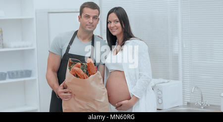 Mann und die schwangere Frau mit einem Paket von baguettes Stockfoto