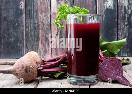 Rüben Saft in ein Glas gegen ein rustikales Holz- Hintergrund Stockfoto