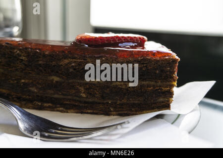 Schokoladenkuchen mit Erdbeeren in Scheiben geschnittene Erdbeeren und Nachfüllen Stockfoto